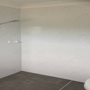 Gaffneys work in progress: marble-look wall tiles and grey floor tiles before fittings are installed